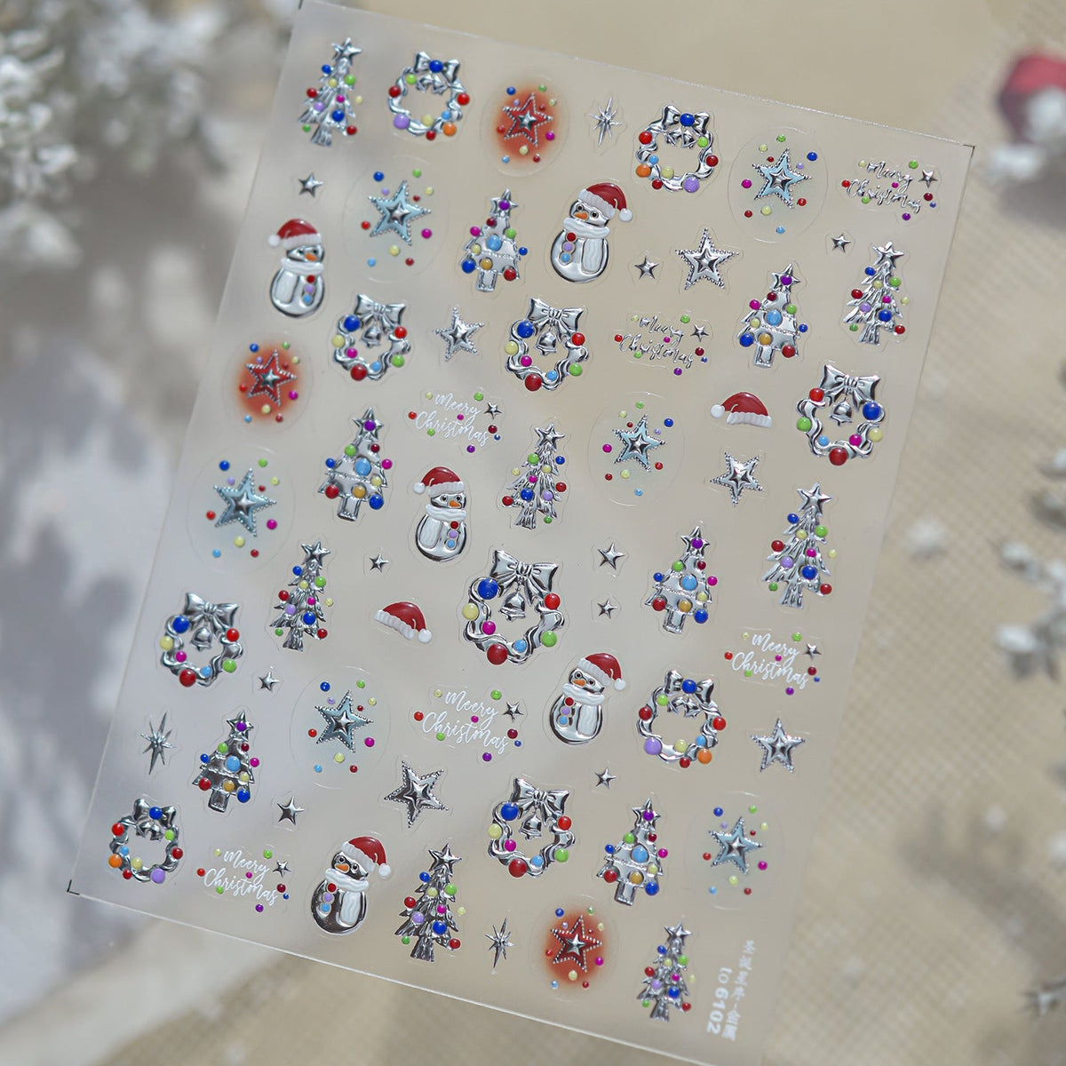 Assorted small festive 3D nail decals for Christmas, including tiny Santa hats, ornaments, stars, and snowflakes in silver and colors, designed for easy holiday nail decoration.